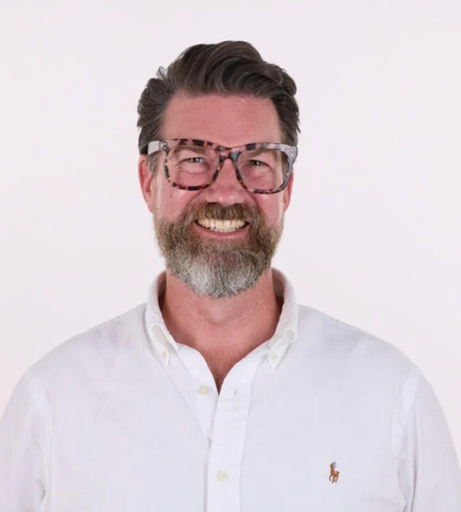Man wearing a white shirt with a logo on a white background