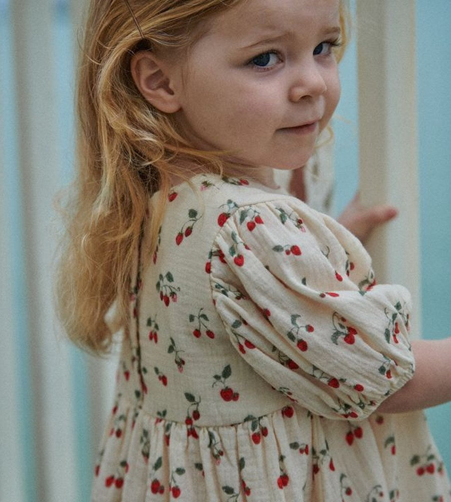 Young girl wearing a floral dress with a light blue background