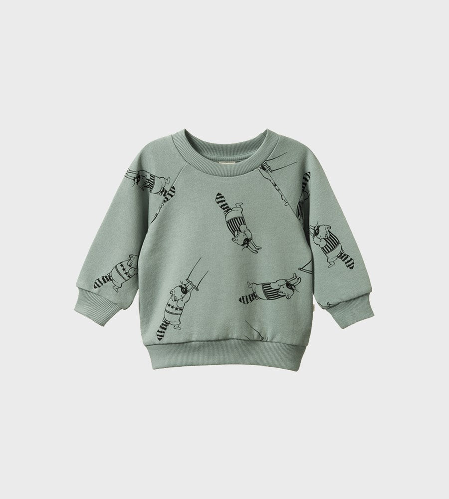 Green sweatshirt with black patterns on a light gray background