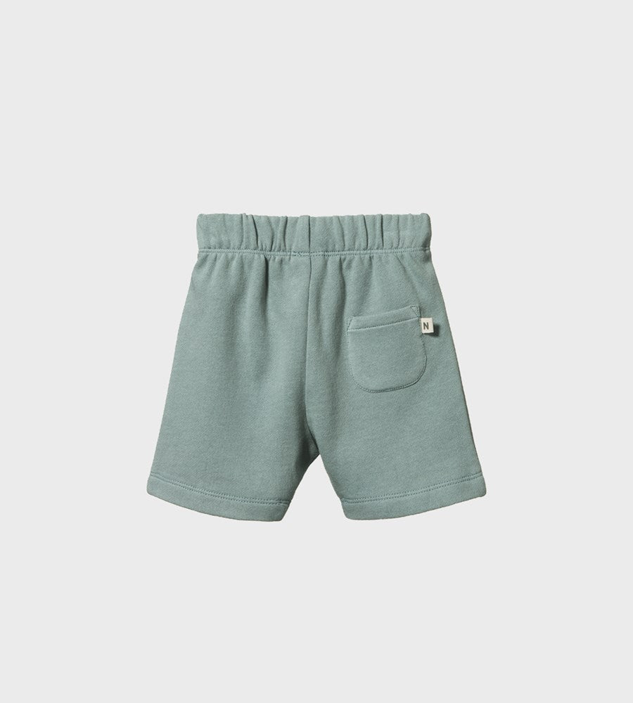 Green shorts with a pocket on a light gray background