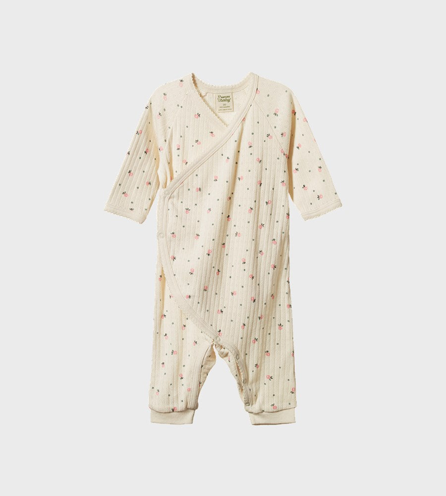 Baby onesie with a subtle pattern on a white background