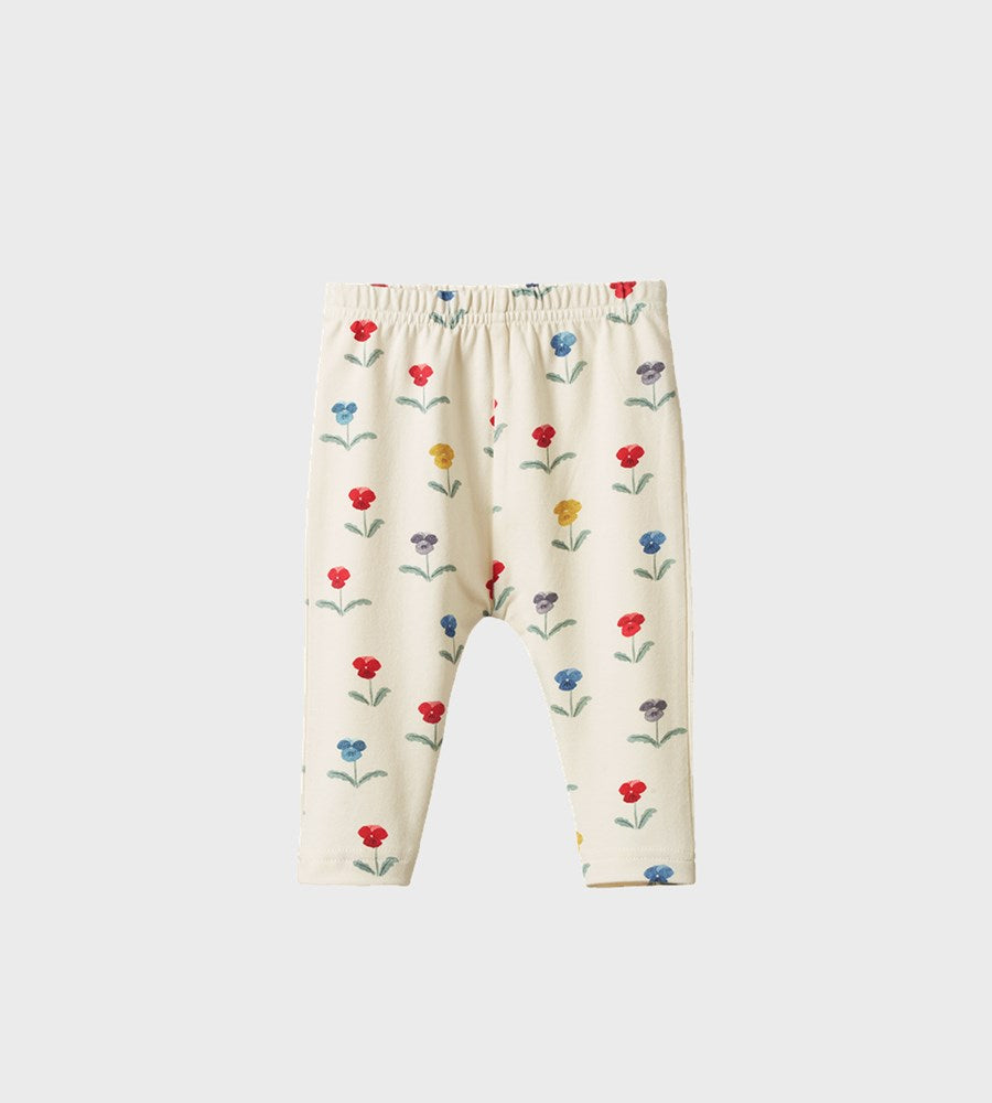 Cream-colored leggings with colorful floral pattern on a white background