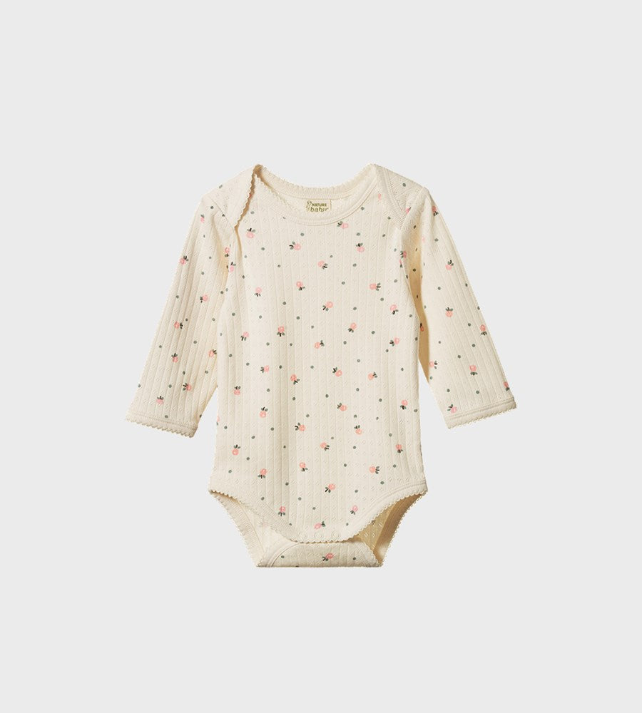 Baby onesie with floral pattern on a white background