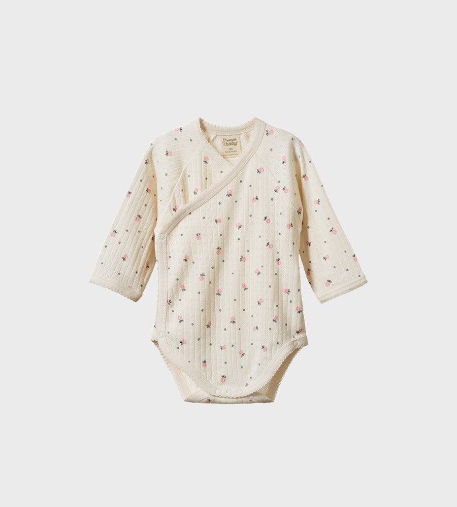 Baby wrap dress with floral pattern on a white background