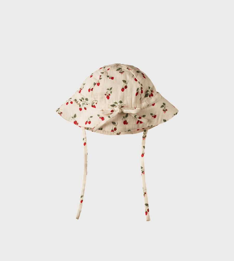 Beige baby sun hat with cherry pattern on a white background