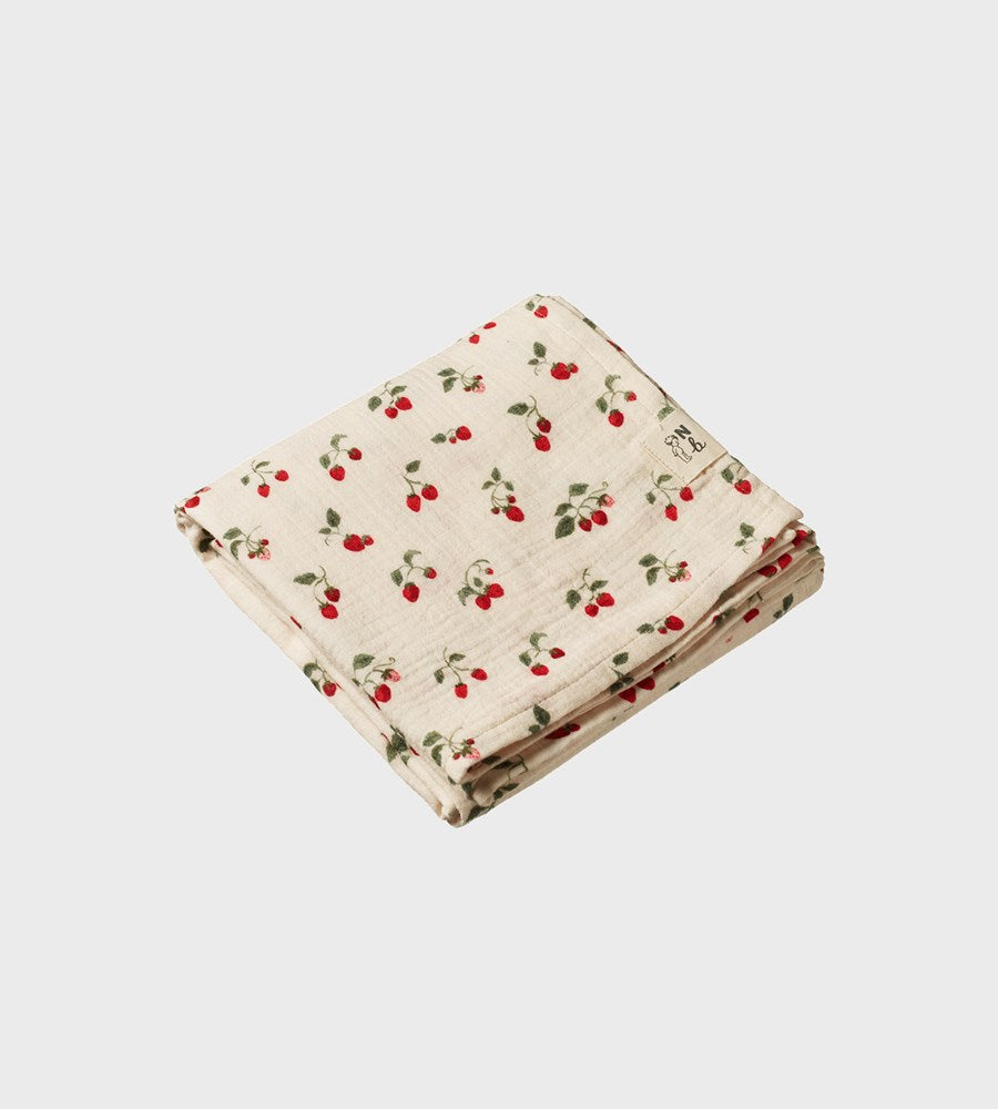 Folded fabric with cherry pattern on a light gray background