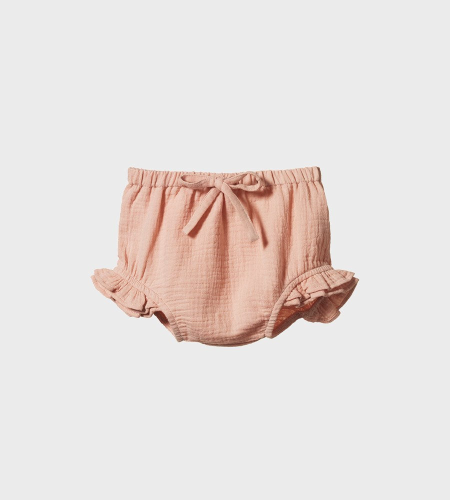 Pink baby bloomers on a light gray background