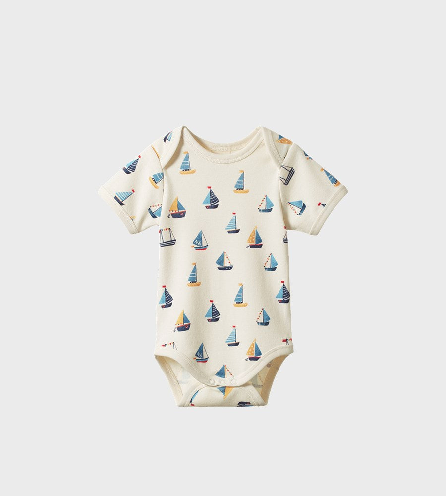 Baby onesie with sailboat pattern on a white background