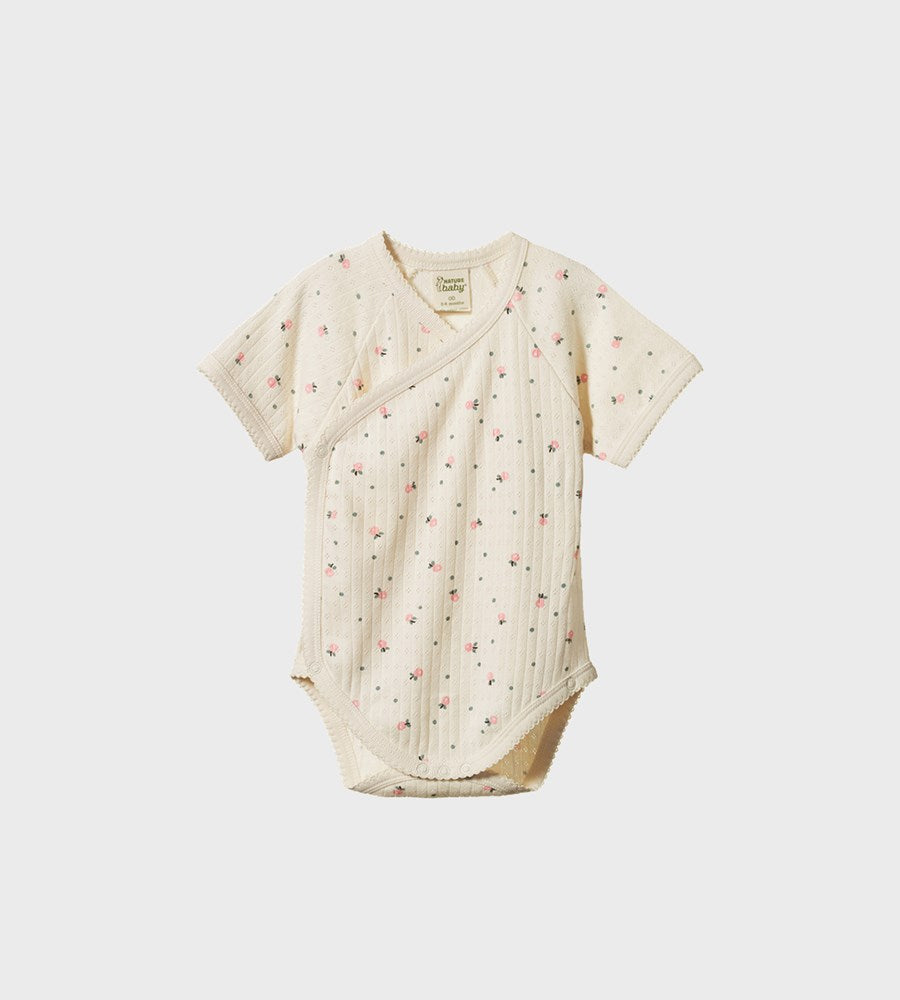 Baby romper with floral pattern on a white background