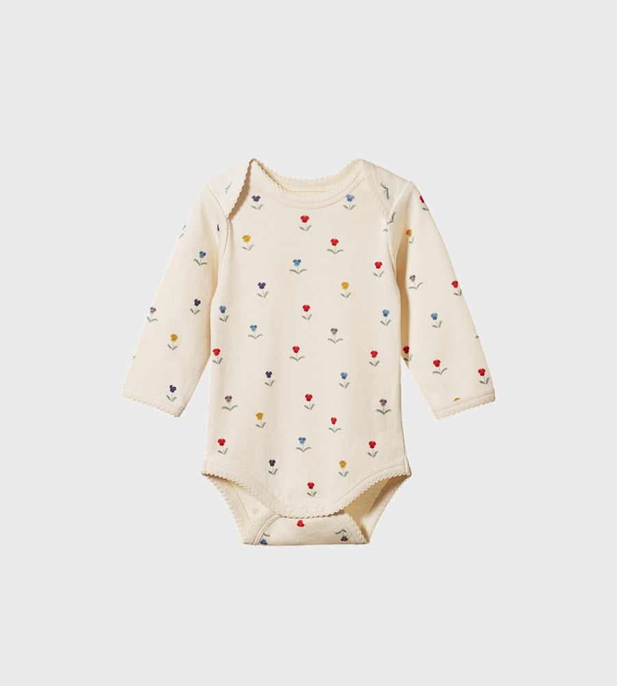 Baby onesie with colorful heart pattern on a white background