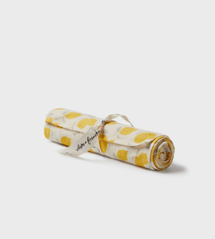 Rolled-up fabric with yellow pattern on a white background