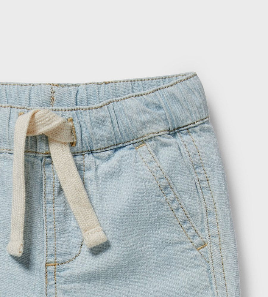 Light blue denim pants with a drawstring on a light gray background