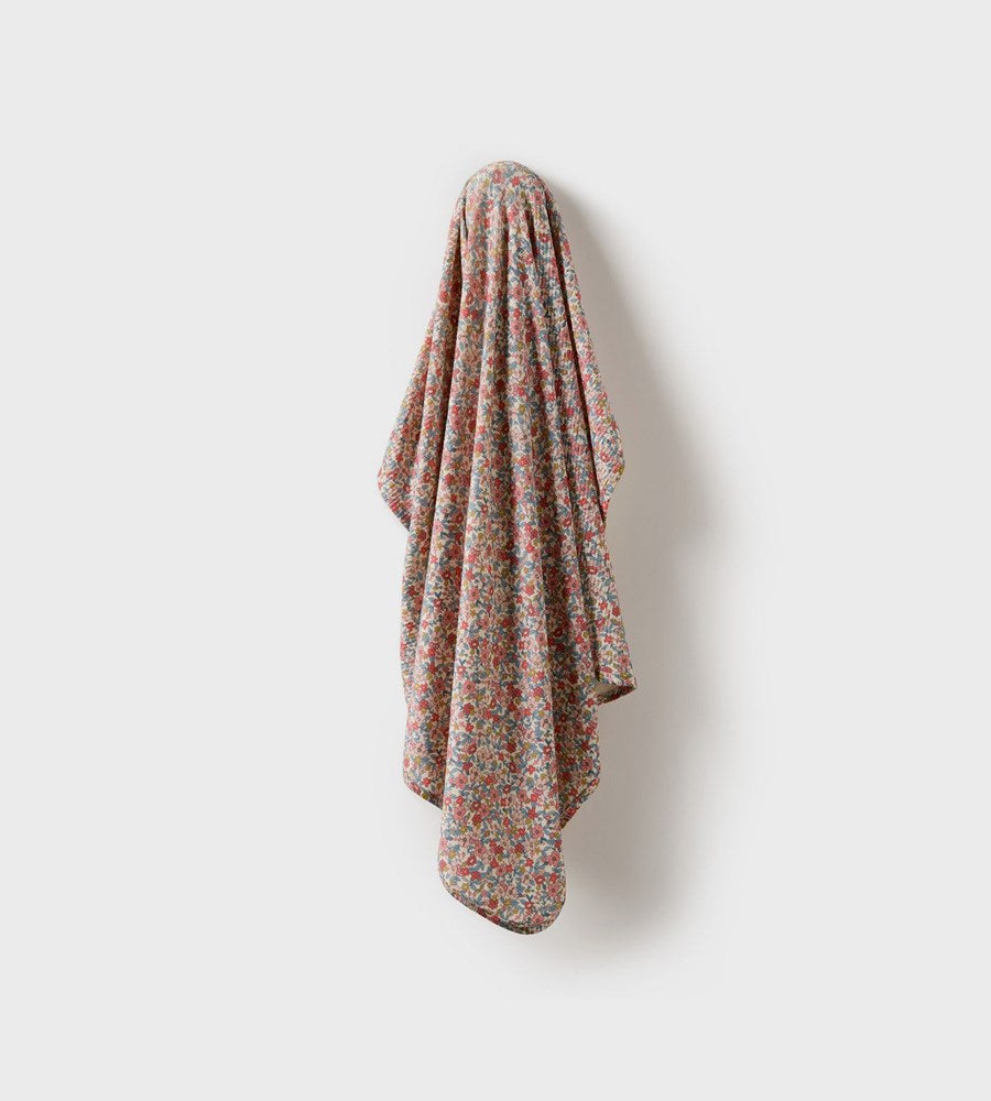 Floral patterned towel hanging on a white wall