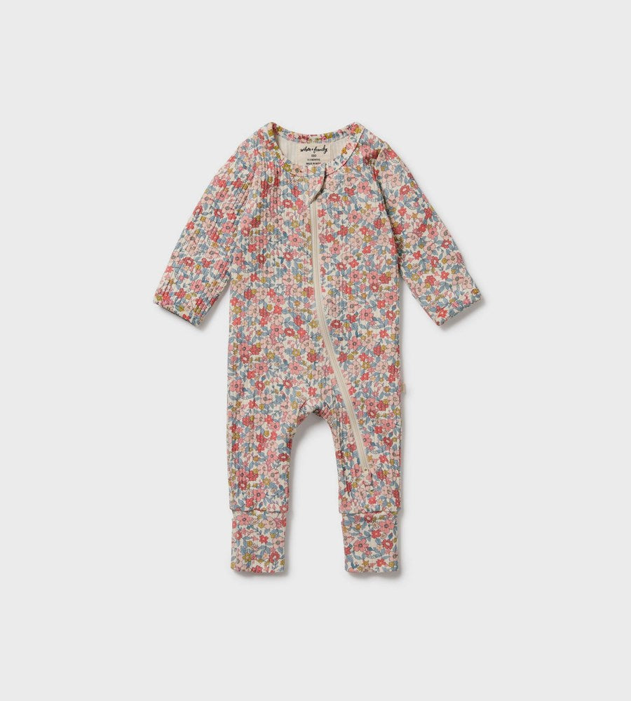 Floral patterned baby onesie on a white background