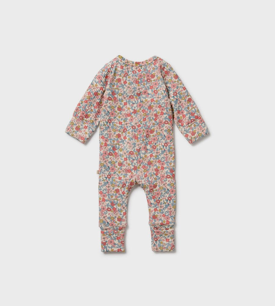 Floral patterned baby onesie on a light gray background