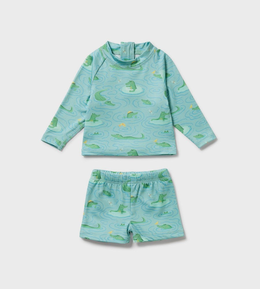 Children's blue rash guard with green alligator pattern on a white background