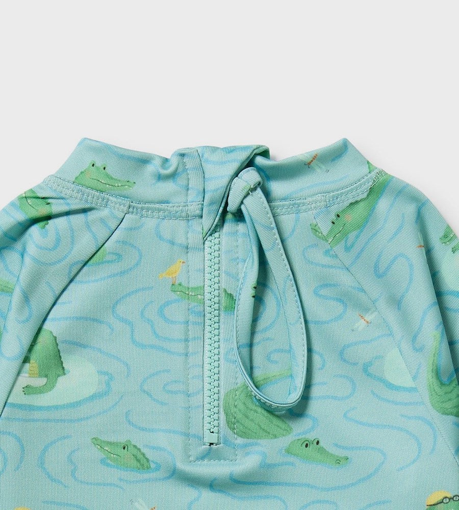 Children's swim shirt with alligator pattern on a light blue background