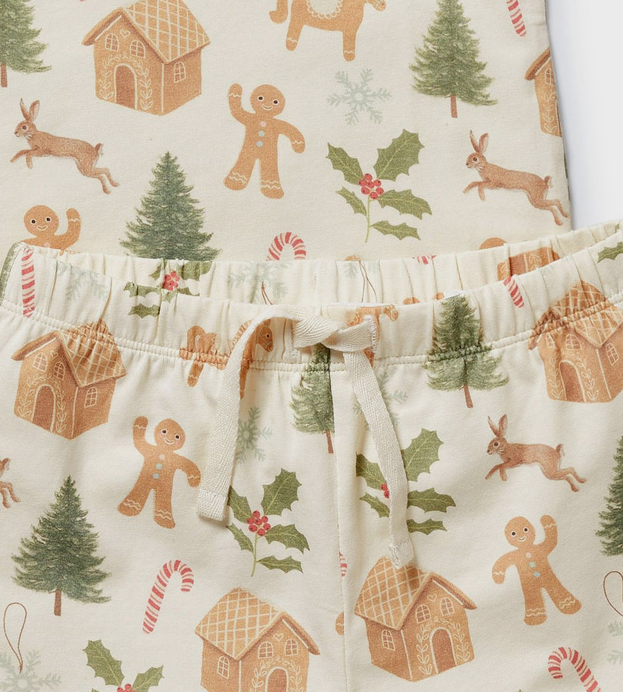 Children's pajama shorts with Christmas-themed pattern featuring gingerbread men, trees, and houses on a white background.