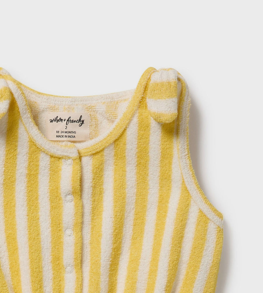 Yellow and white striped baby romper with bear ears on a light gray background