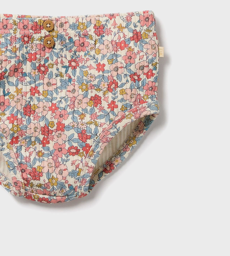 Floral-patterned fabric with buttons on a white background