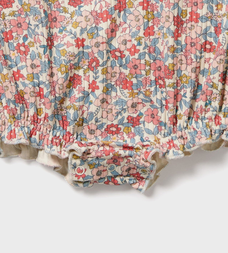 Floral patterned fabric with ruffled edge on a white background