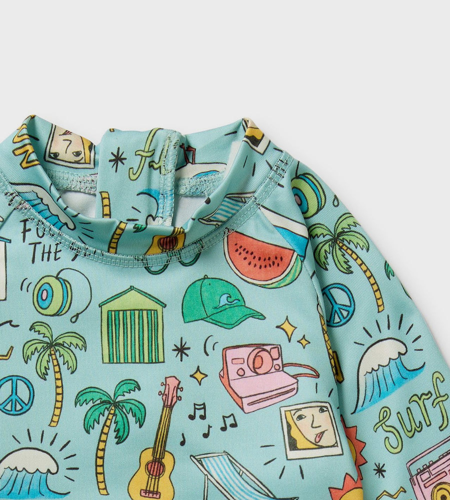 Children's shirt with colorful summer-themed design on a light blue background
