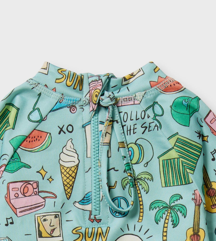Light blue shirt with colorful summer-themed graphics on a white background